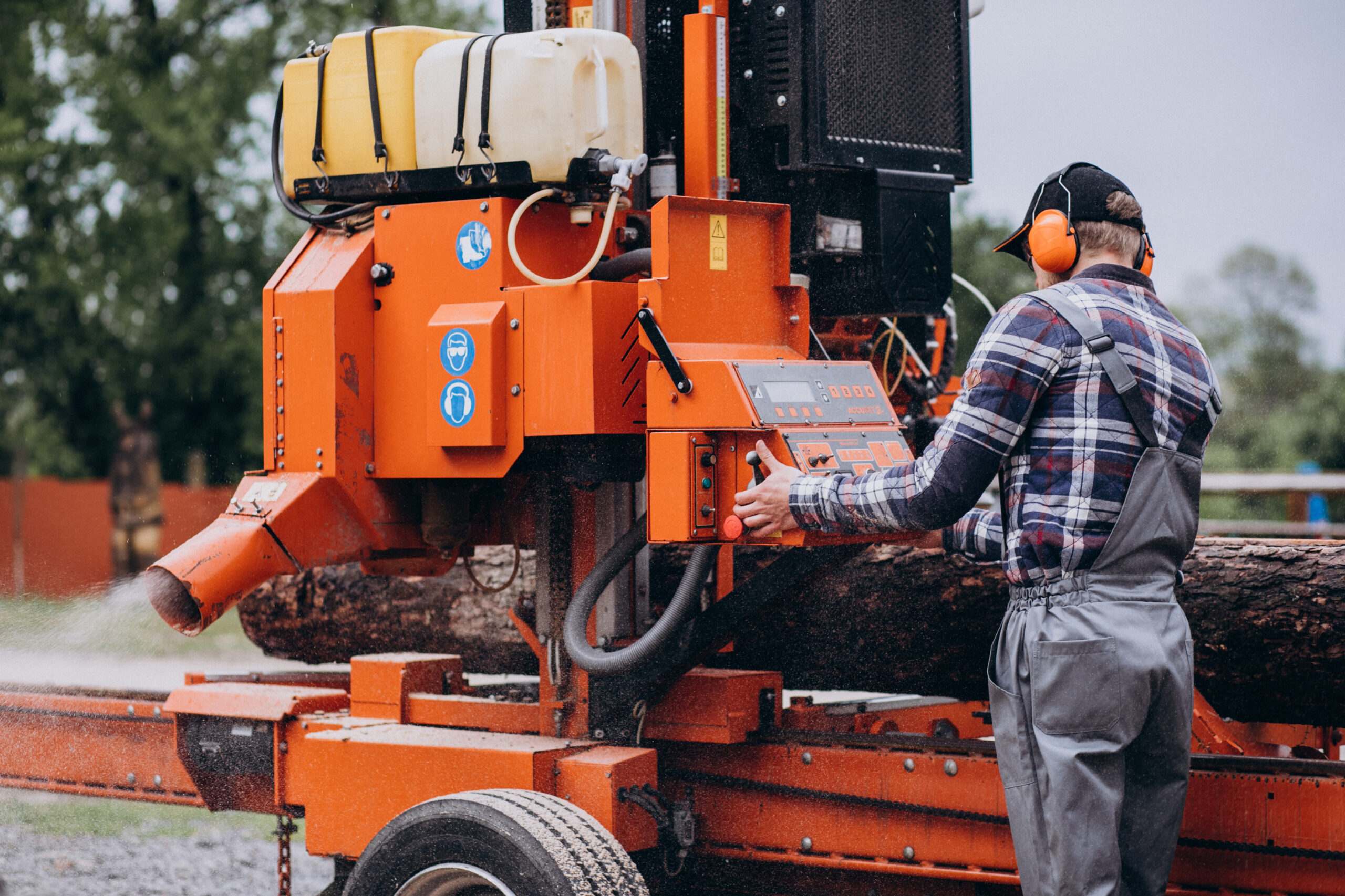 carpenter working on a sawmill on a wood manufacture